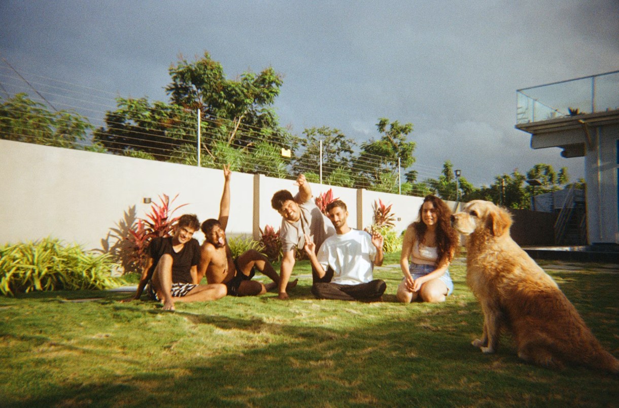 Friends and a dog on a lawn