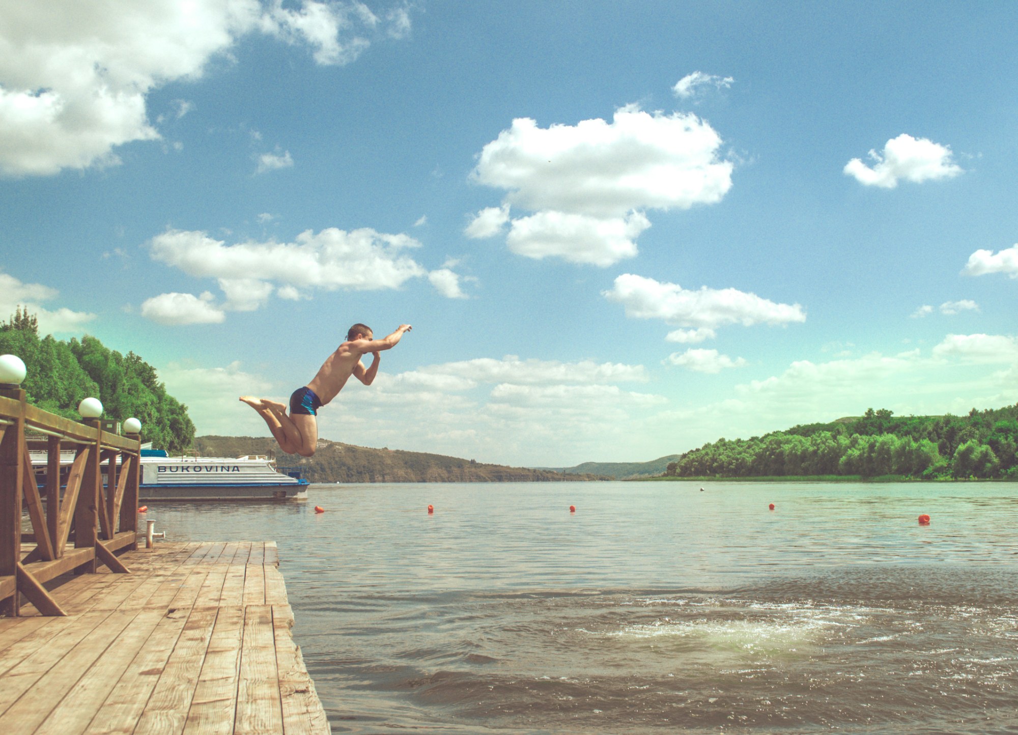 Diving off a dock into a lake