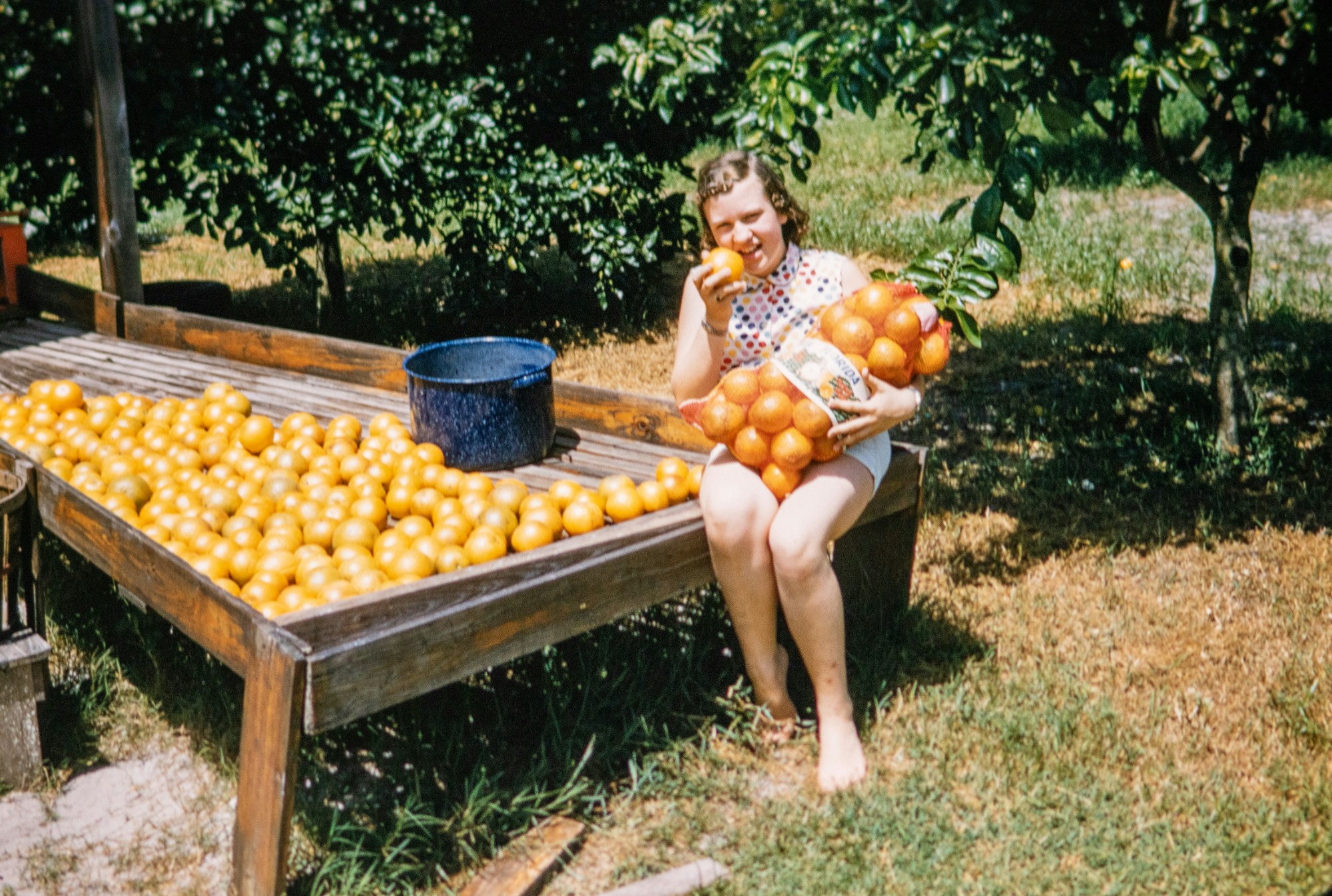 Girl with a bag of oranges